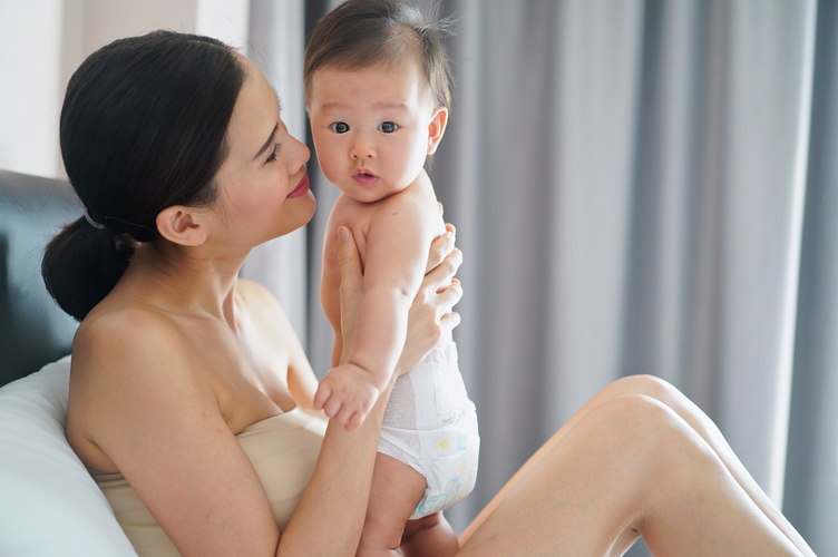 crop-shot-of-beautiful-asian-mother-holding-baby-o-2023-11-27-05-27-23-utc