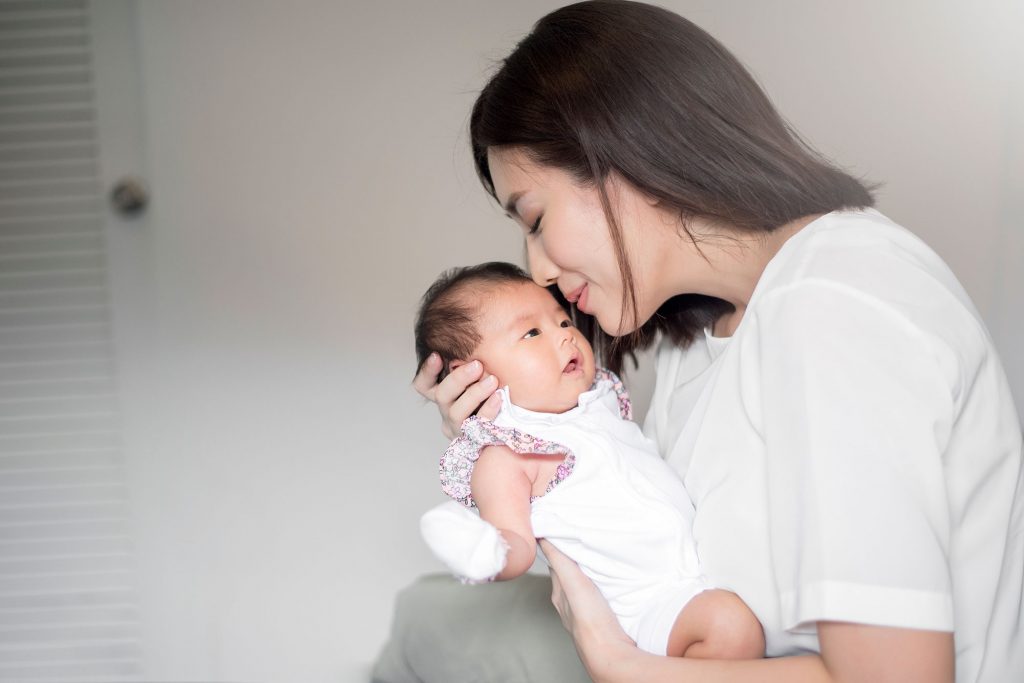beautiful-woman-holding-newborn-baby-her-arms-1024×683